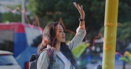 Fototapeta premium Raising hand female commuter signalling bus at stop pole with backpack smartwatch and stock charts