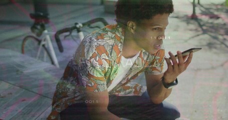 Holding smartphone man wearing floral shirt crouching on plaza with bicycle, smartwatch, overlays