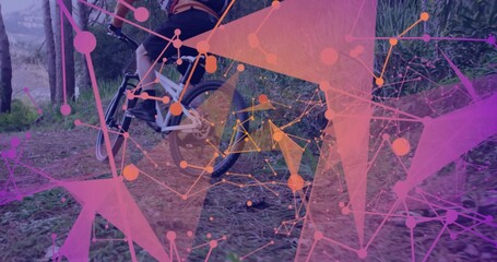 Male cyclist wearing helmet and jersey pedaling mountain bike on dirt trail, with network shapes