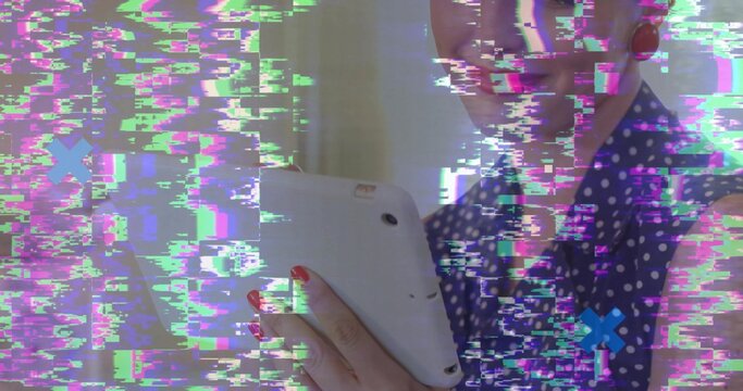 Holding woman wearing polka dot blouse using tablet in front of blinds, glitch overlay, copy space - Powered by Adobe