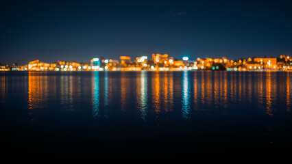 Fototapeta premium City Skyline Reflected on Water Surface with Night Lights