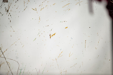 The unattended glass door has traces of crayon and graffiti that have not yet been completely erased.