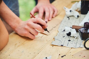 Writing with an antique pen. Historical reconstruction of the 19th century