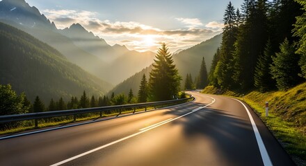 Winding mountain road through evergreen forest with sunbeams illuminating the landscape