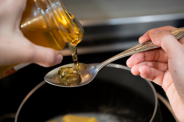 Honey or Maple Syrup Pouring on Spoon