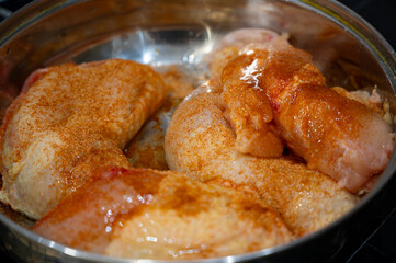 Marinated Chicken Drumsticks with Spices in Frying Pan