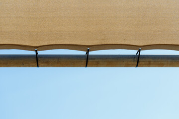 Tan Shade Fabric Attached to Metal Pipe with Zip Ties © de-nue-pic