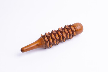 Close-up of carved wooden massage roller on white background, ideal for reflexology, wellness,...