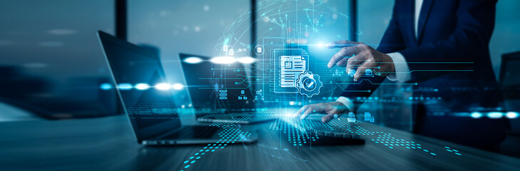 Administrator using laptop with analysis data Document Management organizing files, digitizing...