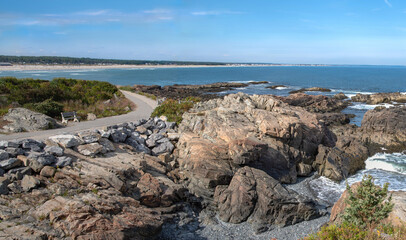 Oceanside Walkway in Maine:  A paved path curves beside beaches and rough coastal rocks along the shoreline near Ogunquit, Maine.
