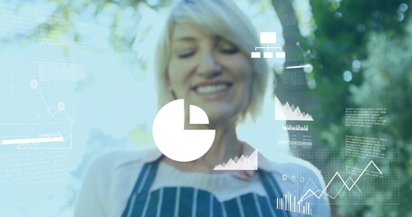 Examining woman in striped apron studying digital overlays in garden, with pie chart and graphs