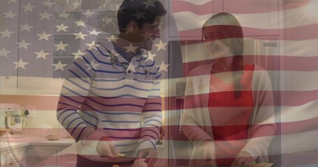 Couple chopping vegetables with knives on cutting boards in home kitchen, with US flag overlay