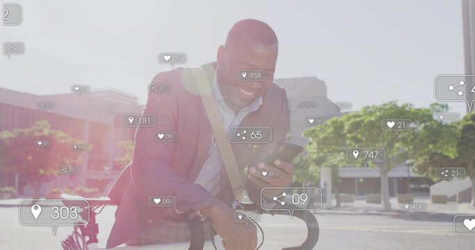 Smiling businessman leaning on bicycle checking smartphone in plaza with messenger bag social icons