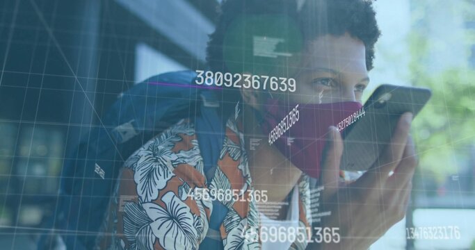 Man with red mask carrying backpack, speaking into phone near glass building, with data overlays