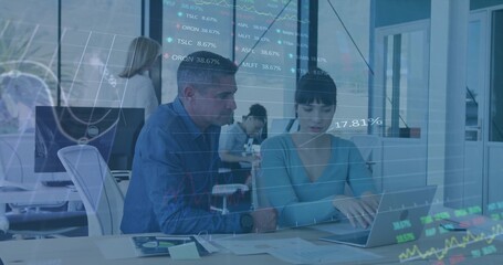 Collaborating professionals analyzing financial data overlays in open-plan office, with laptop