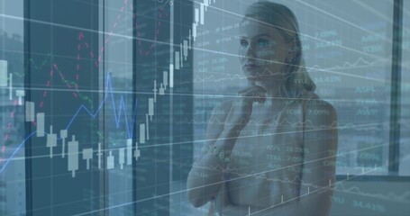 Adult female analyst reviewing financial charts on glass wall in office, city skyline, copy space