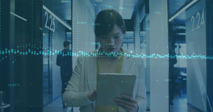 Interacting businesswoman tapping tablet in corporate hallway, with data overlay and numbered doors