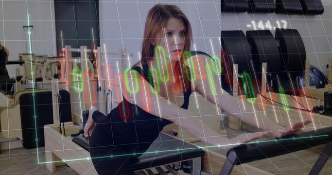 Kneeling woman in workout gear extending arms on reformer in Pilates studio, with candlestick chart
