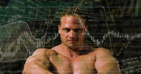 Showing shirtless athlete flexing muscles in studio, with stock market graphs and tickers