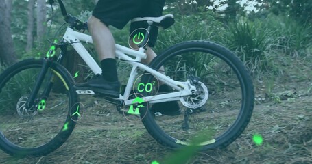 Naklejka premium Riding cyclist wearing sportswear pedaling forest trail, with electric mountain bike and eco-icons