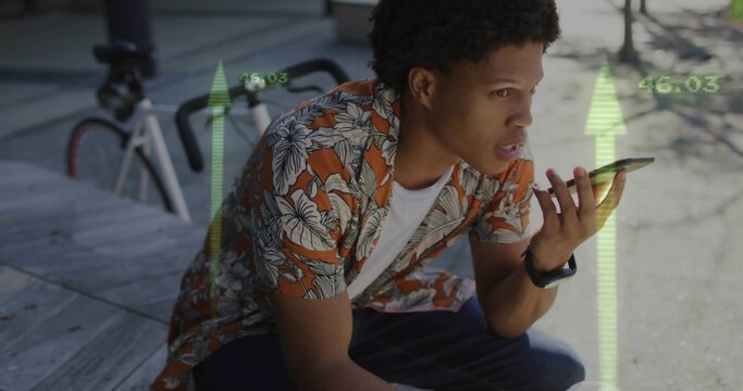 Man wearing floral tee sitting on wooden deck by bicycle speaking into phone with digital overlays