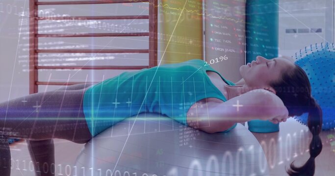 Balancing adult woman in athletic wear over stability ball in fitness studio with data overlays - Powered by Adobe