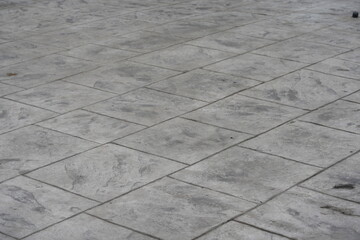 Fototapeta premium Gray stone tile floor background with modern industrial texture. Concrete pavement pattern for architecture, design, business presentation, or construction concept.