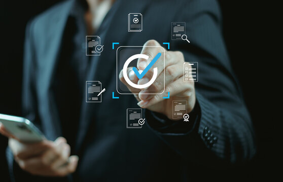 Businessman touching approved document icon on digital documents for approve business project proposals. Quality assurance and online evaluation of business concept.