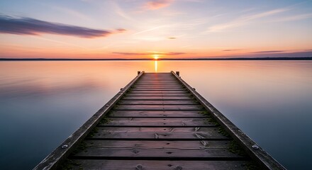 Obraz premium Wooden Pier Leading to Calm Lake at Sunset with Pastel Skies and Beautiful Horizon View