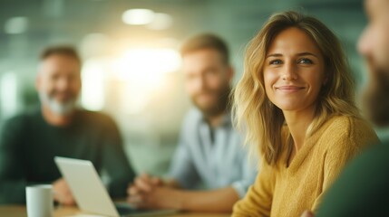 Obraz premium Young woman smiling while engaging in a business meeting, actively listening and collaborating with her diverse team of colleagues, fostering a productive and positive work atmosphere
