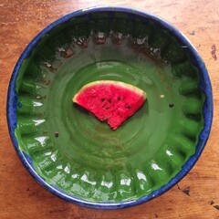 Juicy Watermelon Slice in a Green Ceramic Bowl