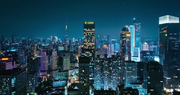 Aerial shot of a vibrant modern city skyline with illuminated skyscrapers and downtown financial district at night in Nanjing.