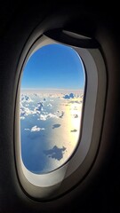 Fototapeta premium Airplane window view of clouds and ocean