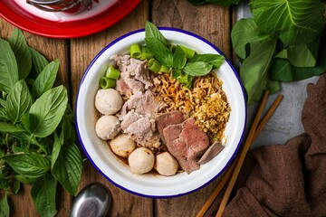 Noodle soup with sliced pork, pig blood, meatball and Thai morning glory,Nam Tok noodles with instant noodles