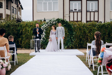 wedding ceremony of the newlyweds on the glade