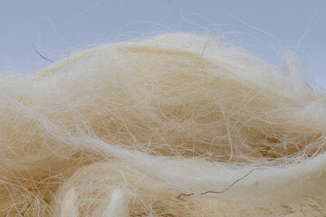 Close-up of fluffy animal wool, representing natural fibers, warmth, and craft