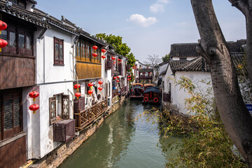 Ancient Chinese water town. Suzhou, China, Traditional houses on a narrow river canal boats and a small bridge