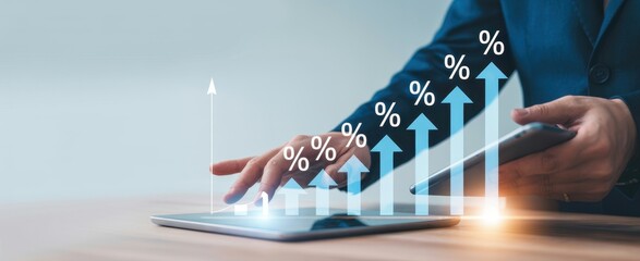 Financial Growth and Technology: A close-up shot of a person's hand interacting with a tablet, overlaid with animated graphics of a financial growth chart.
