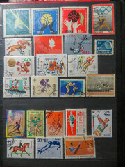 A Vibrant Collection of Used Postage Stamps Featuring Flowers and Athletes From Various Nations