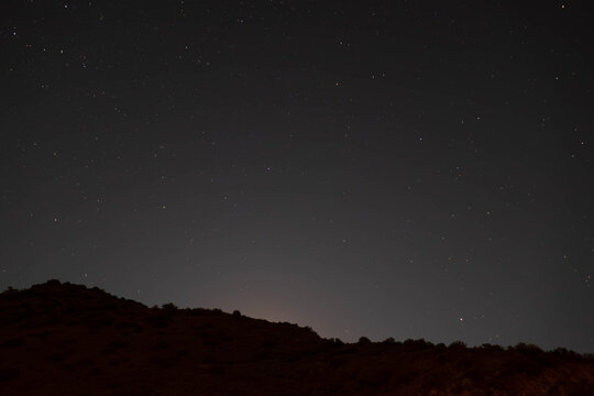 Stars illuminate a mountain ridge