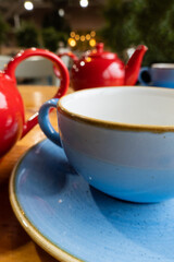 Bright cups of tea with teapot in creative composition. Morning rituals
