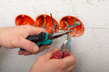 insulation of electricity in sockets, hands in close-up