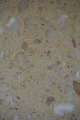 beige stone terrazzo texture with polished surface and natural mineral inclusions. Beige concrete background with decorative stone chips for interior and architecture design.