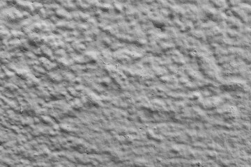 Close-up textured gray concrete wall surface with subtle patterns and details