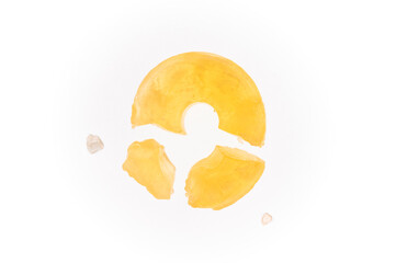 Broken, yellow hard candy on white background