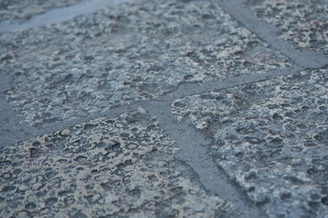 Stone pavement texture – close up of grey stone surface with rough natural pattern, background of old urban street floor, construction and architecture material for design, abstract and decorative con
