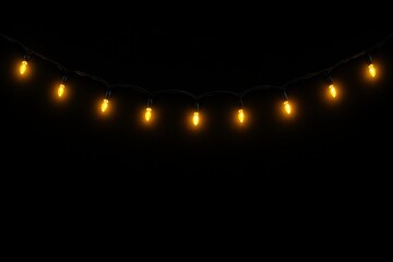 String of warm yellow lights glowing against a dark background creating a cozy atmosphere