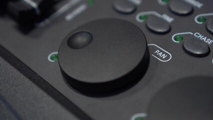 Close-up: finger adjusts Pan shuttle on lighting console