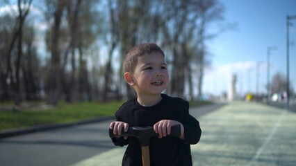 A Joyful Young Child Happily Riding a Colorful Scooter in the Park, Embracing Fun and Adventure