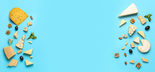 Frame made of tasty cheese and nuts on blue background